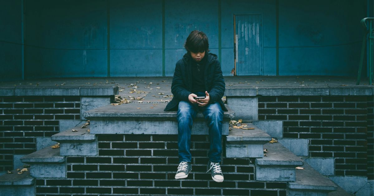 Young boy with mobile phone outdoors