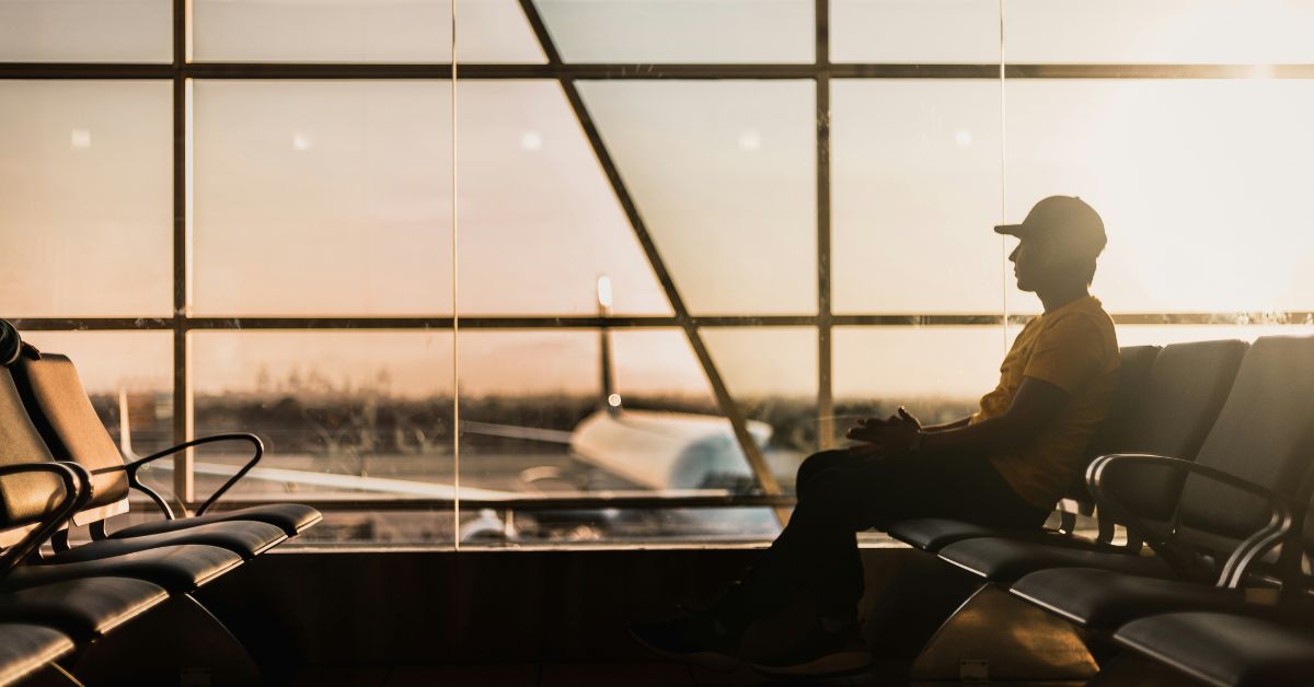 Young man sitting in airport lounge
