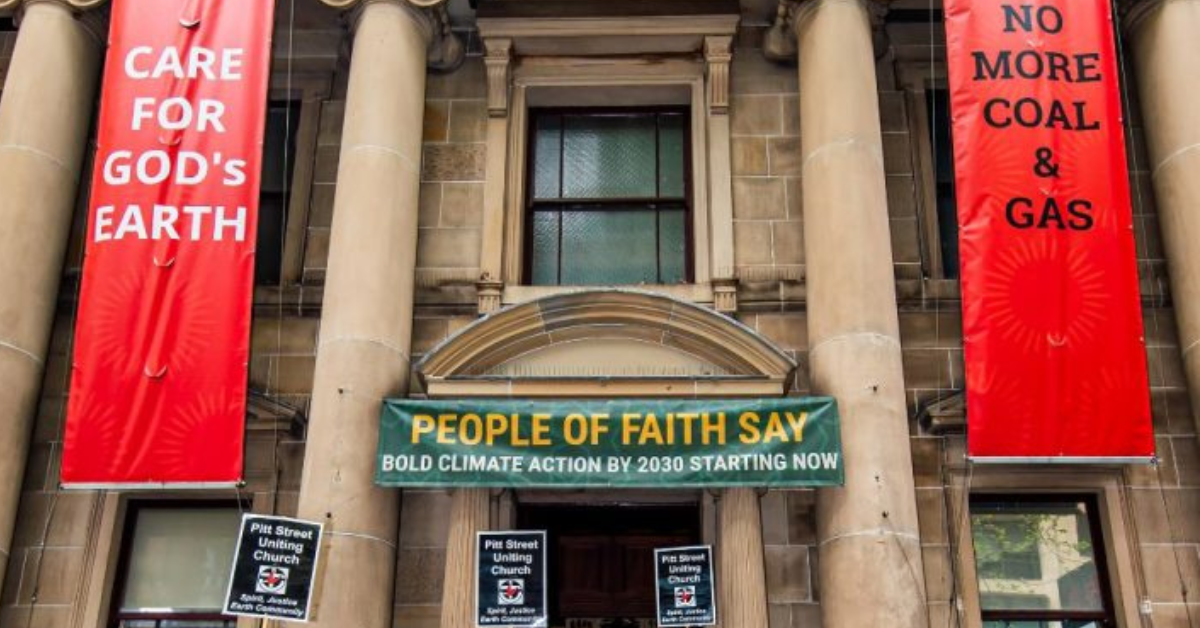 banners outside a church protesting against climate change