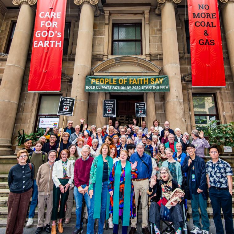 Many people gathered outside a church with protest signs