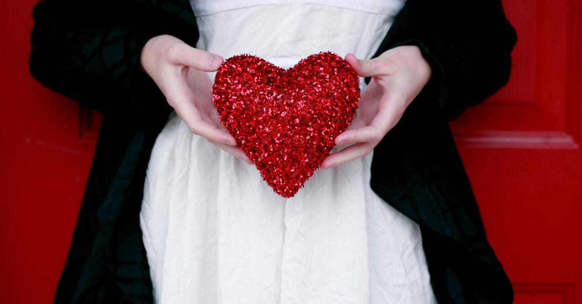 Women holding red heart